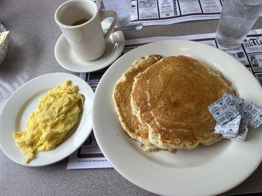 Short stack of pancakes with two eggs