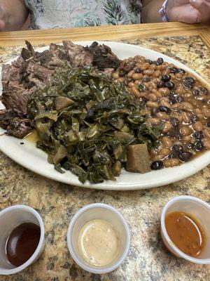 Chopped brisket with 2 sides-collard greens and dirty beans.