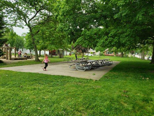 Picnic tables, there are indoor restrooms in the building in the back