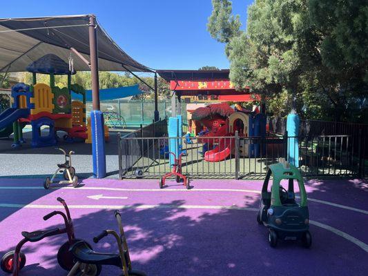 The Little Prodigy Preschool and Daycare Center race track with tricycles and play cars.