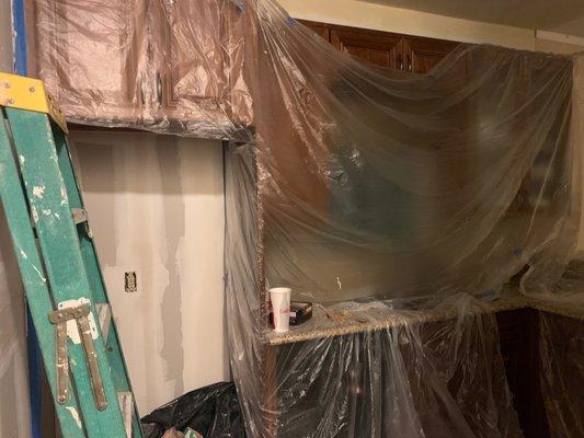 Plastic mold remediation coverings in downstairs neighbor's kitchen