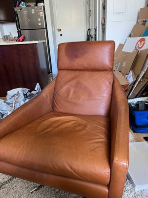 Photo of stain after attempting to clean with three different stain removers for leather upholstery.