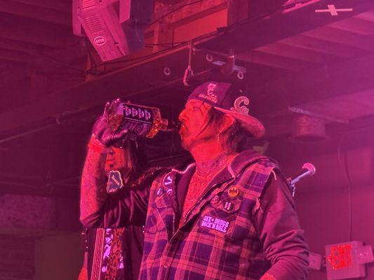 Lead singer of Kickin' Valentina in red stage lighting!