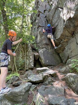 Climbing along summit rock trail