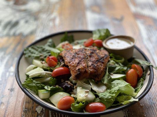 Lemon pepper salmon on a garden salad.