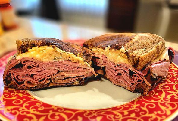 Reuben sandwich with pastrami and corned beef on marble rye.