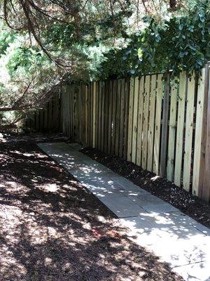 Carpentry repair of Rotted Privacy Fencing, using new Pressure Treated wood. We also installed custom natural flagstone walkway.