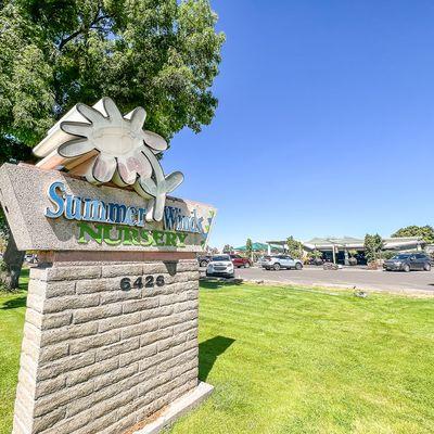 The SummerWinds Nursery address and street sign and a view of our parking lot and store.