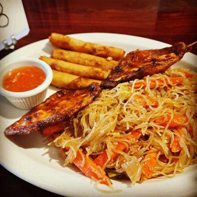 The pancit combo with BBQ pork skewer and spring rolls