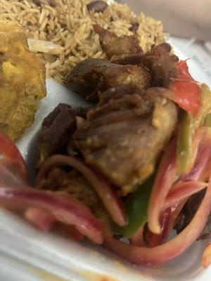 Griot (pork) with rice & beans Haitian style and fried green plantains  & delicious bell peppers