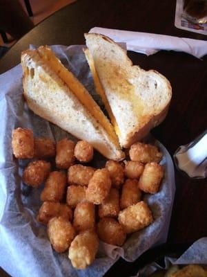 Grilled cheese and tots on sour dough bread