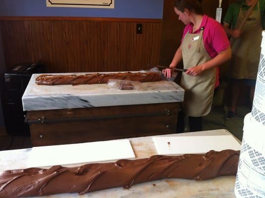 Cutting fresh salted caramel fudge.