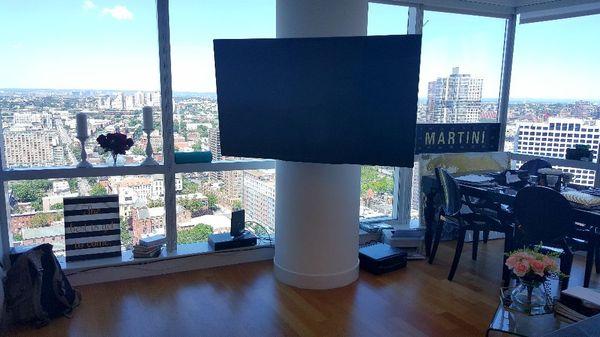 77 inch LG OLED Mounted On Round Concrete Column With Wires Concealed. Jersey City, 70 Greene St.