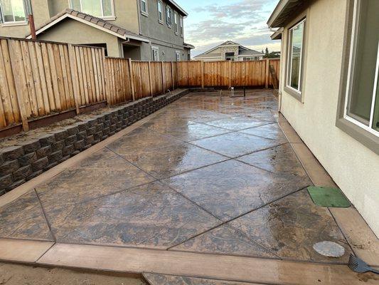 Stamped concrete with a small retaining wall