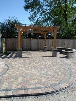 Sierra hollandstone patio with basalt copthorne accent. With cedar pergola and half moon fire pit.  Downers grove