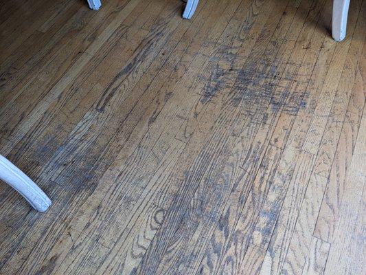 Before: Close-up of floor under dining table.