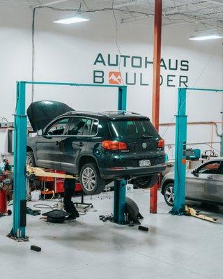 VW on the rack inside the shop.