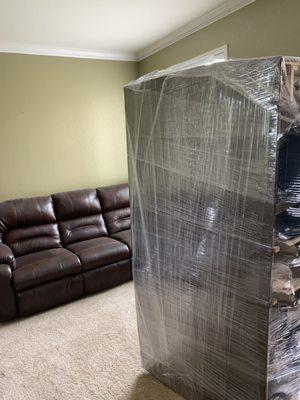 A quick shrink wrap to both couches before the load!