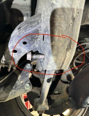 The bolt completely loosened, as shown at the emergency shop after I almost crashed two days after this shop did my alignment.