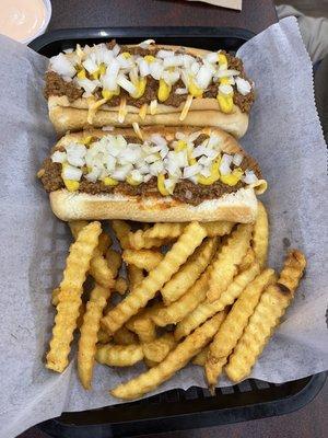 Chili dogs with cheese and onions and French fries.