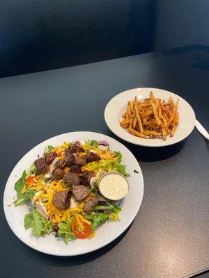 Teriyaki fillet salad with creamy, garlic dressing, and fries