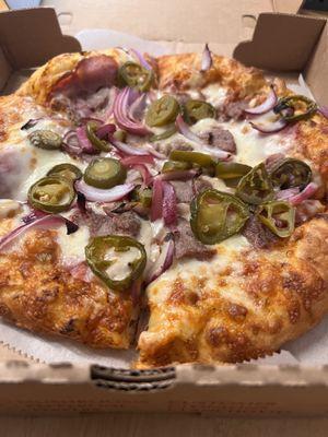 Order from Zella's that was hand tossed crust with spicy red pepper sauce and ham, steak, jalapeños, and red onions as toppings!