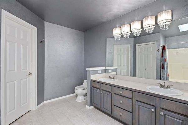 We recently updated the paint, light fixture, flooring and restained the vanity in this master bedroom