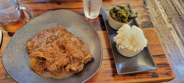 Smothered pork chops with collards and rice.