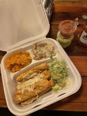 Chicken taquitos plate and a modelo . That's an asada burrito hiding behind the container