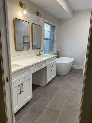 Classy and clean! White shaker vanities with a knee drawer.