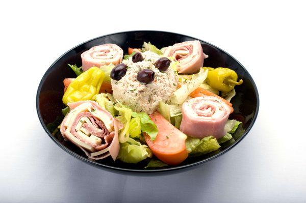 A delightful bowl of Chef salad Genova's To Go, filled with mouthwatering meat, cheese, and vibrant veggies.