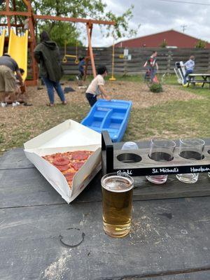 Beer flight $14 and pizza slice $5. Cool spot very family friendly