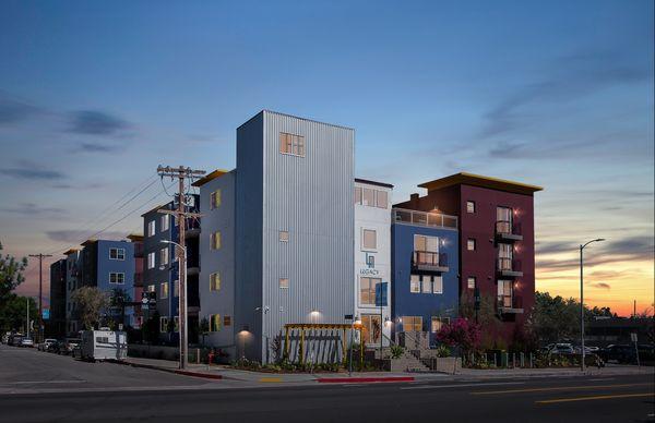 Exterior of the Legacy apartments at dusk.