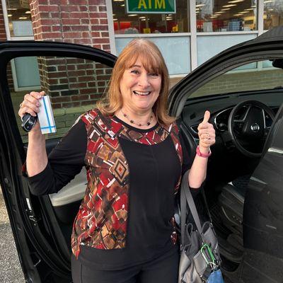 Happy lady with her keys being retrieved from being locked in her car