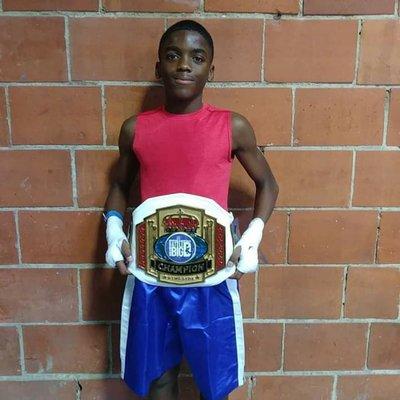 Devon from our kids class pocking up the championship belt at The Battle of Big D July 2019. He went 3-0 in this tournament.