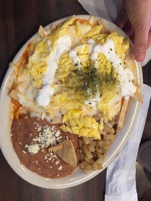 Chilaquiles (tortilla chips) w scrambled eggs.  Good n spicy.