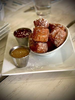 Beignets with caramel and raspberry sauce