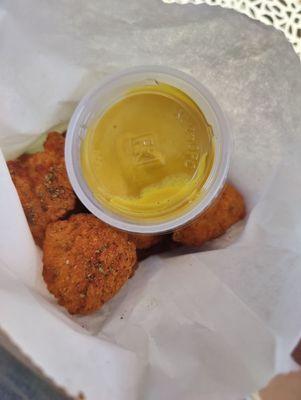 Popcorn chicken to-go with mustard on the side