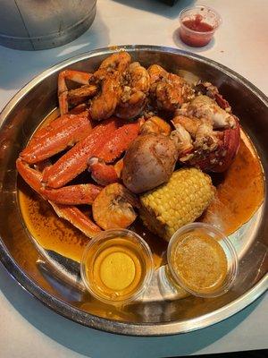 Crab legs, shrimp, lobster tail, corn, potato, hard boiled egg