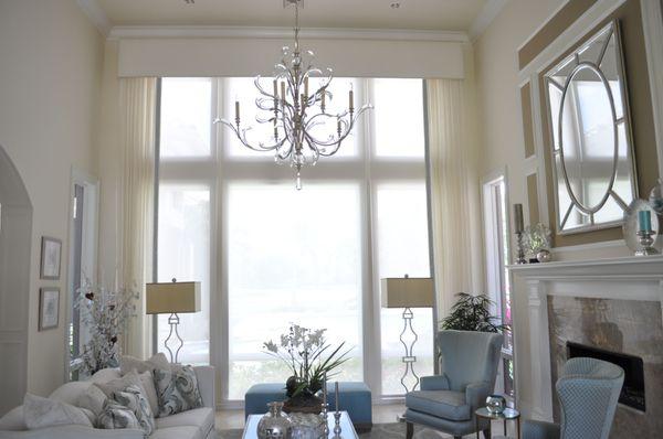 Screen shades diffuse the light, white linen side panels and cornice soften the look.