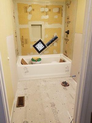 During! New tub and underlayment.