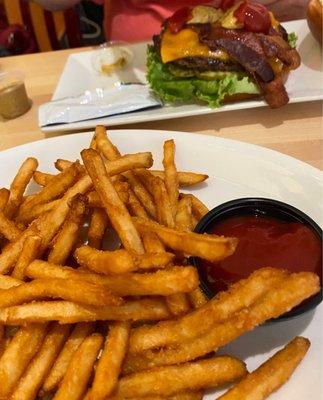 Bacon burger and table fries.