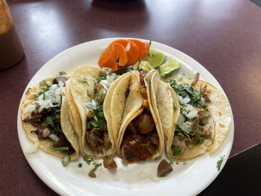 From left to right: Beef head taco, tripe taco, tongue taco, carnitas taco