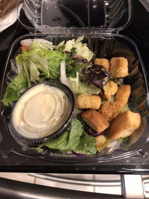 Very small side salad, with mostly croutons, but did have a lettuce mix, a tomato and onion slices.