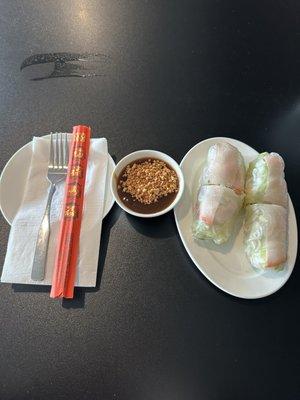 Freshly made spring roll with pork, shrimp, lettuce, mint, and vermicelli noodles along with their peanut sauce.