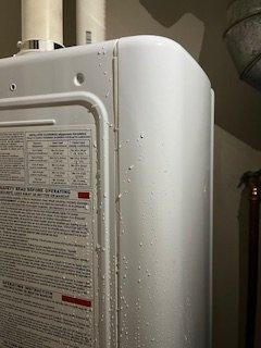 water running down the tankless water heater into our closet