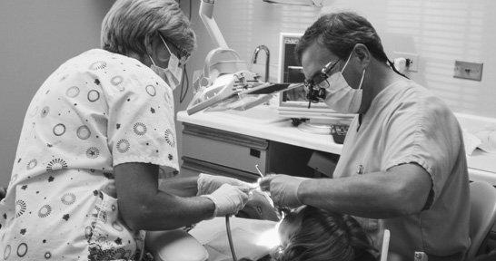 Dr. Siewert and hygienist, Kim, working on a patient.