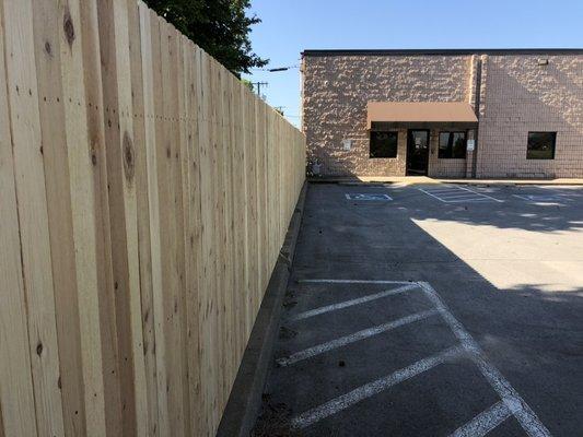 Dog ear cedar privacy fencing on a commercial property