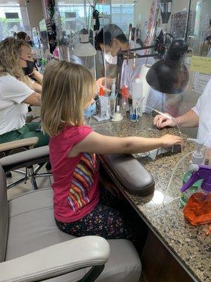 Second youngest getting her nails done