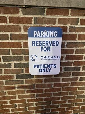 3 reserved parking spots for patients in the lot , first come first served